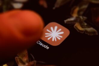 Claude app icon on a smartphone screen with mathematical formulas in the background