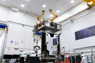 Northrop Grumman MRV robotic satellite in orbit above Earth with arms extended