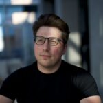 Igor Babuschkin founder of River AI standing in modern office
