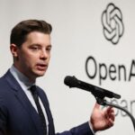 Brad Lightcap speaking at a technology conference podium