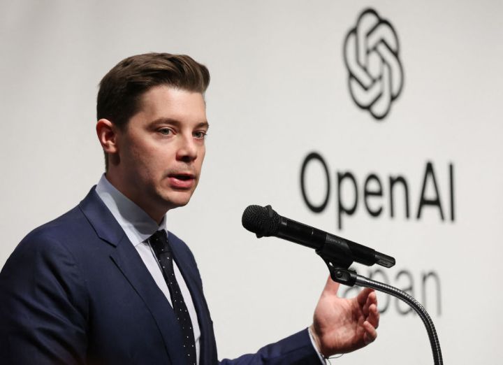 Brad Lightcap speaking at a technology conference podium